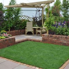 a garden with brick walls and green grass