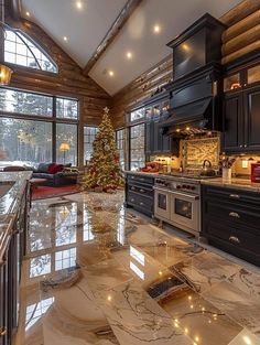 a kitchen with marble counter tops and black cabinets, christmas tree in the corner window