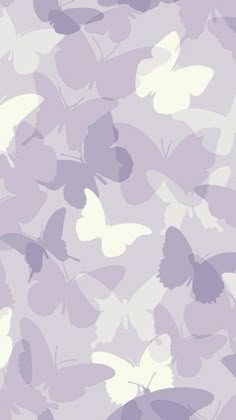 purple and white butterflies are flying in the air