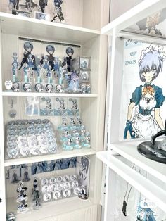 a display case filled with lots of blue and white items on top of wooden shelves