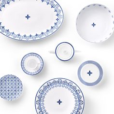 blue and white dinnerware is laid out on the table