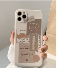 a person holding up a phone case with an image of a teddy bear on it