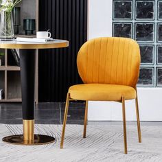 a yellow chair sitting next to a round table