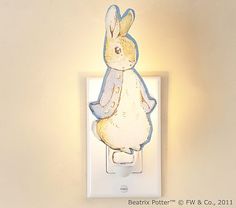 a light that is on the side of a wall with a white rabbit in it