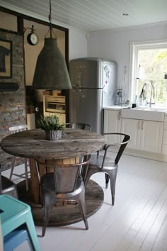 a kitchen table with chairs around it and a stove in the backgroung