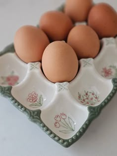 an egg tray with six eggs in it