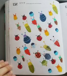 an open children's book with colorful bugs on it