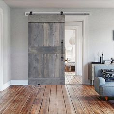 an open sliding door in a living room with wood flooring and white painted walls