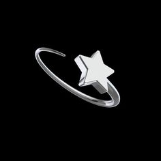 a silver ring with a white star on it's middle and an arrow in the middle