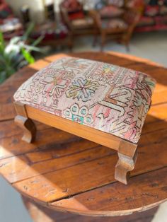 a wooden table with a cushion sitting on top of it