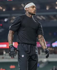 a man in black uniform standing on the field