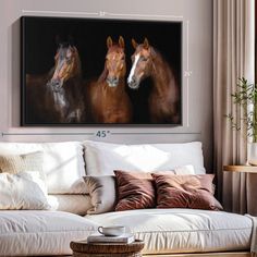 three horses are shown in this living room with white couches and brown pillows on the floor