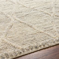 a close up of a rug on a wooden floor with a wood flooring surface