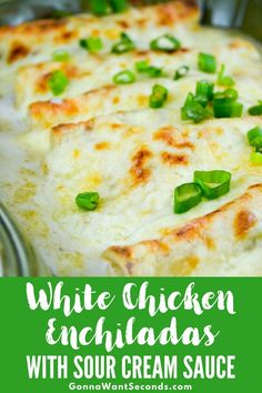 white chicken enchiladas with sour cream sauce in a casserole dish