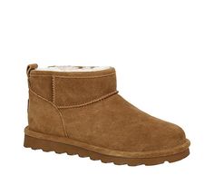 Bearpaw Shorty Women’s Fur Boot  Get warmth up to your ankles in the Shorty women's fur Boot by Bearpaw. With a suede upper featuring BearCoat™ Rain and Stain Repellent to protect against the elements, this pull-on Boot ie is perfect for cold days out and about. The lining & footbed offer warm cushioning while the outsole adds some traction to your unbothered steps.  Suede upper  Pull-on  Wool blend lining  Sheepskin footbed  Treated with BearCoat™ Rain and Stain Bear Paw Boots Outfit Winter, Bearclaw Boots, Bear Claw Boots, Bearpaw Short Boots, Bear Paw Boots, Bearpaw Slippers, Fur Boots Women, Bear Claws, Rack Room