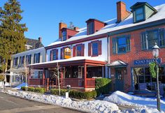 a red brick building with lots of windows and snow on the ground in front of it