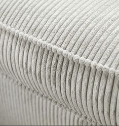 the top part of a mattress with pleaed fabric