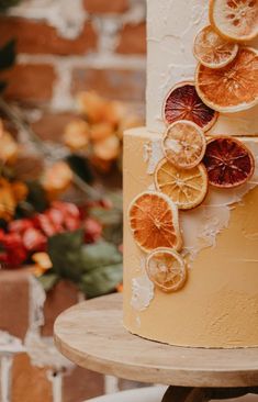 a three tiered cake with orange slices on it