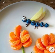 a plate topped with orange slices and blueberries