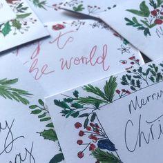 christmas cards with handwritten words and holly berries on them are laid out in rows