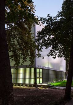 the building is surrounded by trees and grass