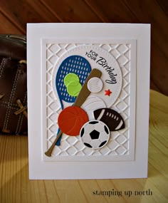 a close up of a card on a table with a glove and bag in the background