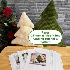 paper christmas tree pillow crafting pattern sitting on a table next to some other papers