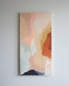 a painting hanging on the wall next to a bed