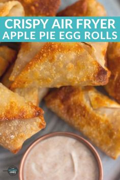 crispy air fryer apple pie egg rolls on a plate with dip in the middle