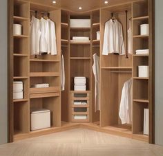 an open wooden closet with clothes on shelves