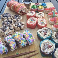 there are many different types of donuts on the table with sprinkles