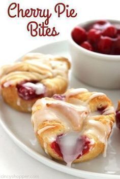 cherry pie bites on a white plate next to a bowl of cherries