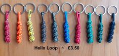 six different colored braided key chains on a wooden surface with the text helix loop $ 3 50