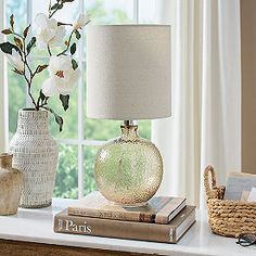 a table with two vases and a lamp on it