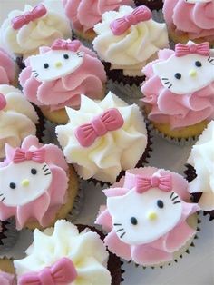 cupcakes with pink and white frosting decorated like hello kitty