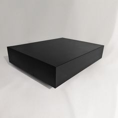 a black box sitting on top of a white surface