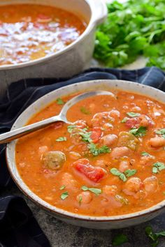 two bowls filled with soup and garnished with cilantro