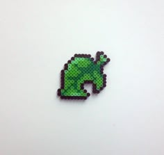 the pixel art is made to look like an animal with green and black spots on it