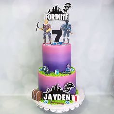 a birthday cake with two figurines on top and the name fortnite