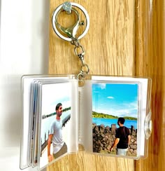 two photos are attached to a keychain that is hanging on a door handle