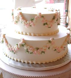 a three tiered cake with flowers on it