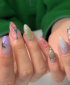 a woman's hands with different colored nail polishes