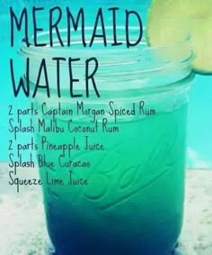 a jar filled with green liquid next to a swimming pool and the words mermaid water on it