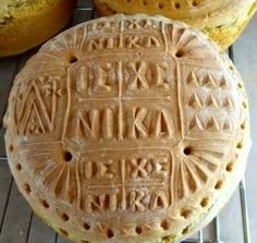 some type of bread with writing on it sitting on a rack next to other baked goods