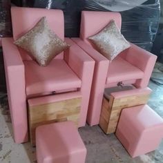 three pink chairs with matching foot stools