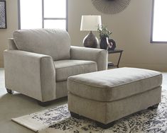 a living room scene with focus on the chair and ottoman