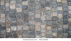 an old cobblestone street with grass growing between the stones