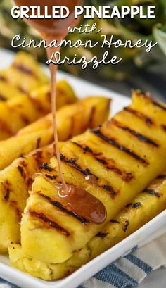 grilled pineapples with cinnamon honey drizzle on a white platter