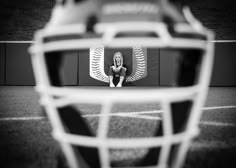 the goalie's helmet is reflected in the mirror