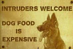 a wooden sign with an image of a dog and the words,'intruders welcome dog food is expensive '